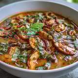 Fragrant Thai Coconut Curry Soup Bowl filled with juicy chicken, crisp vegetables, and aromatic spices, served steaming hot in a rustic bowl.  