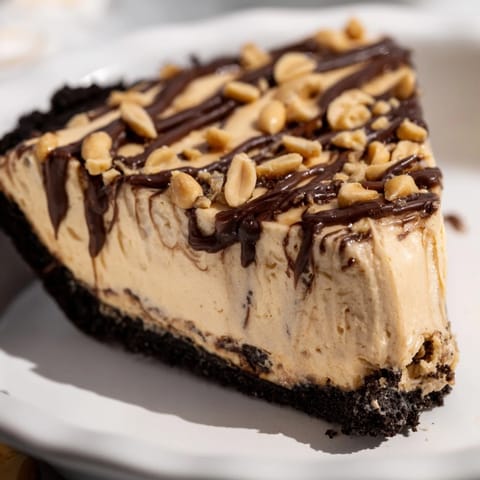 Enjoy a slice of this decadent peanut butter pie, a perfect dessert for any occasion.