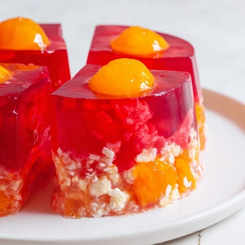 A vintage-style shot of creamy, layered Jell-O Salad, appealing for any gathering.