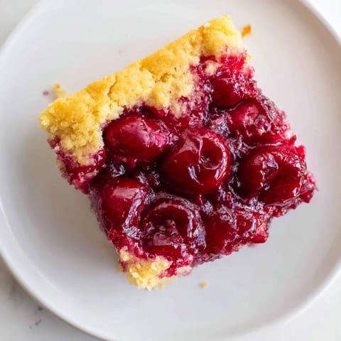 A close-up of a warm, comforting Dump Cake dessert, ready to serve with creamy ice cream.