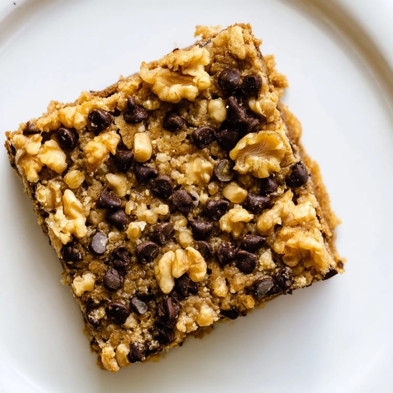 Close-up photo of warm, gooey Blondies, freshly baked and featuring toasted nuts.