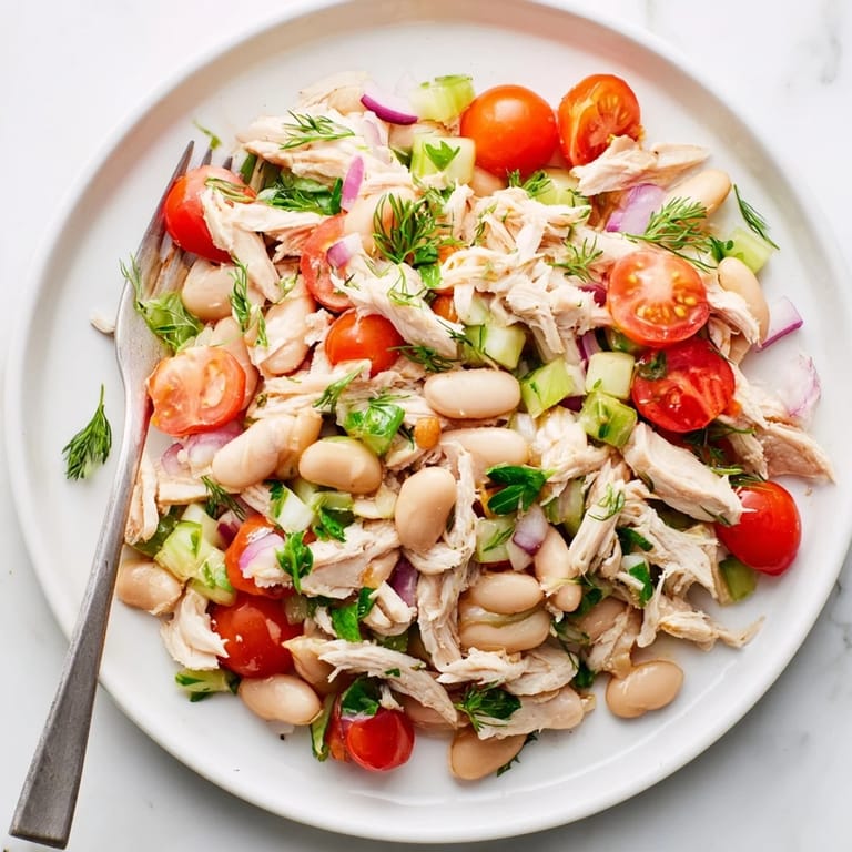 Shredded chicken, celery, and creamy white beans make up this Lemony White Bean Chicken Salad, drizzled with tangy lemon dressing.