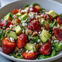 Fresh strawberry avocado quinoa salad with creamy avocado and juicy berries in a citrus dressing.  