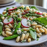 Spring pasta salad with lemon vinaigrette and radishes, a vibrant dish with crisp vegetables and tangy dressing. A refreshing, colorful pasta salad with fresh radishes, spring vegetables, and bright lemon vinaigrette. Light and zesty spring pasta salad featuring tender pasta, crunchy radishes, and a citrusy lemon dressing.